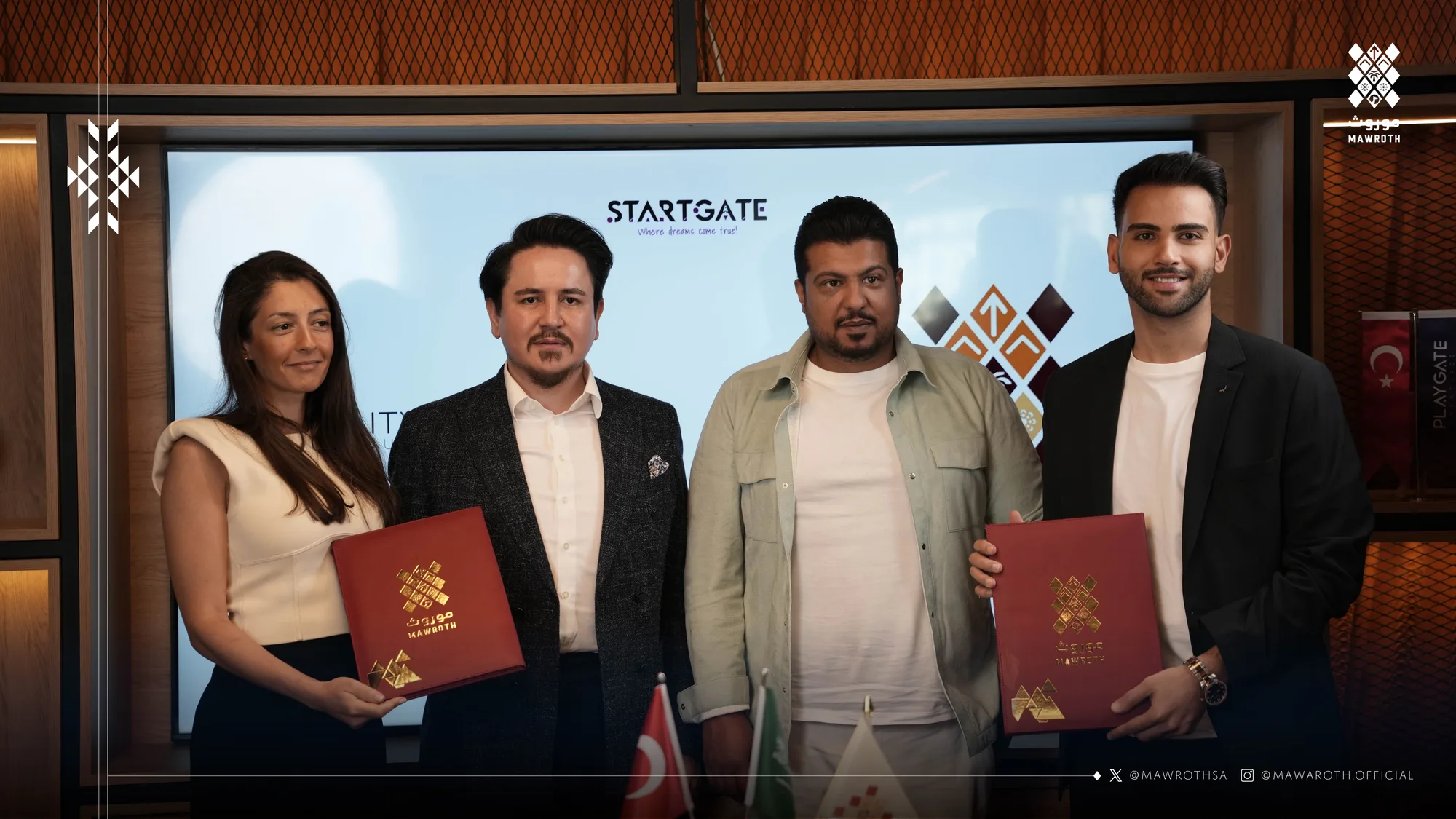 Mawroth and Arvis-RealityArts Studio signatories hold signed red partnership agreement folders at StartGate Istanbul