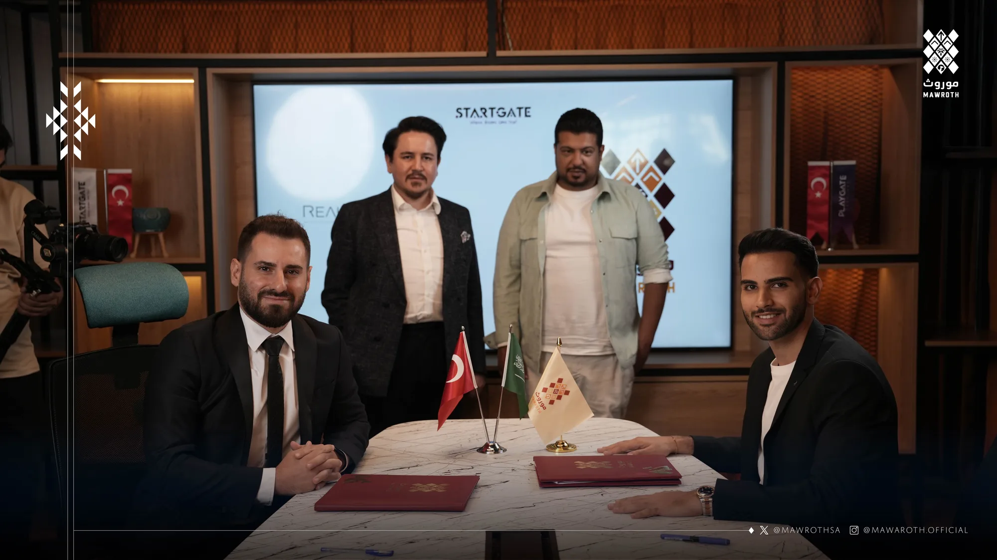 Parties signing the strategic partnership agreement at the table with Turkish and Saudi flags, senior officials standing behind