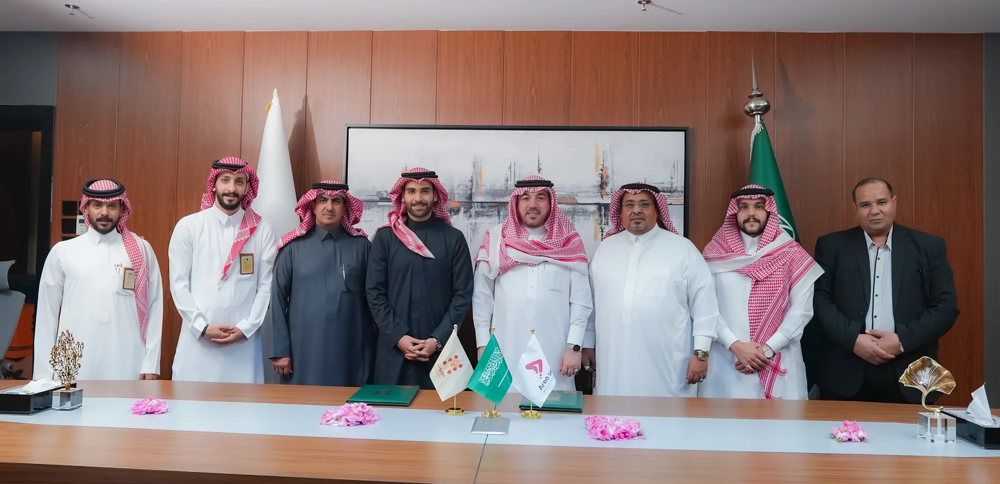 Eight officials from Mawroth, Aria Seven, and Taif Chamber standing together at the signing table after concluding the Nafas Program agreement