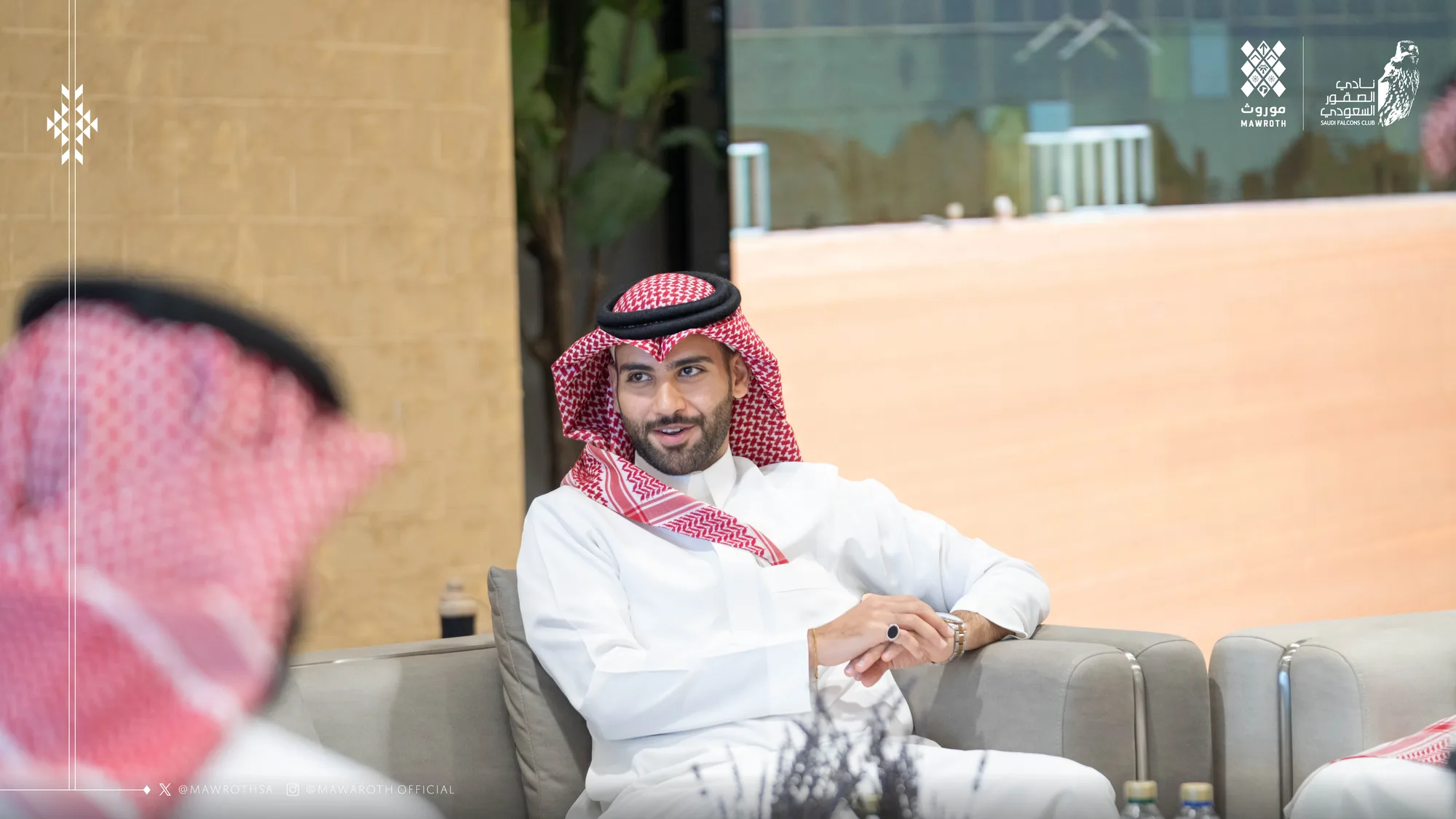 Mawroth founder smiling at the MOU signing table, Saudi flag and Saudi Falcons Club backdrop behind him