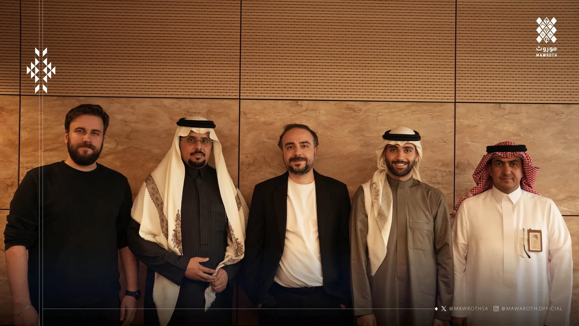 Mawroth and Nodeflam delegations pose together after their strategic partnership meeting on AI and VR — five representatives standing before a warm stone-panel backdrop