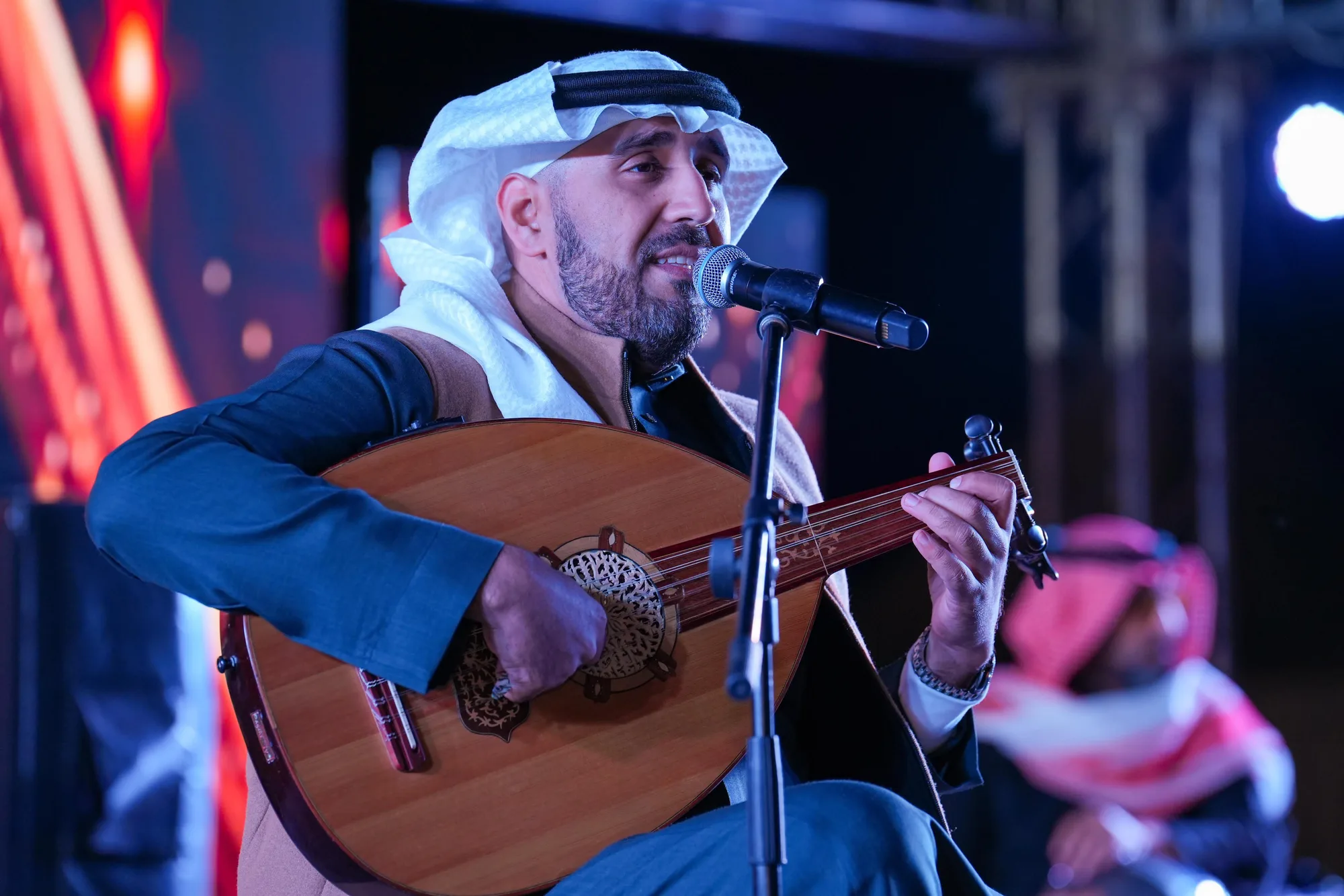 Oud player performing at the Taif Falcon Cup 2025 evening ceremony under stage lights